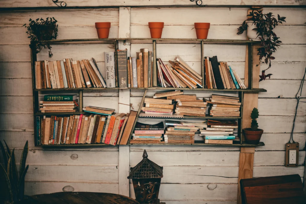Rustic bookshelf overflowing with books, useful for illustrating spring cleaning tips for home organization.