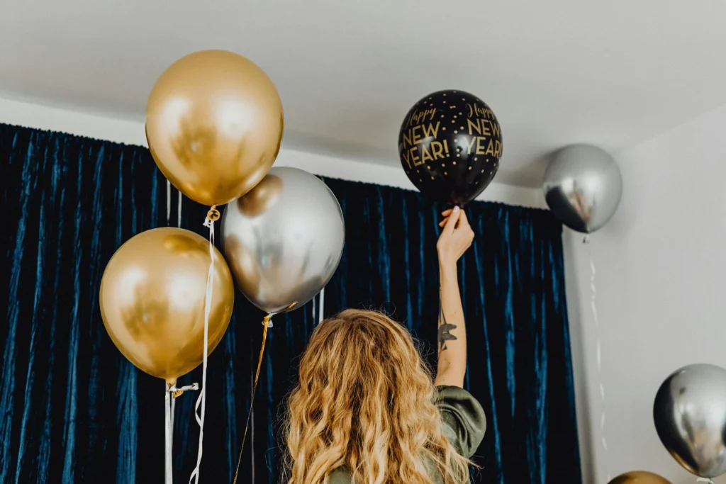 New Year Home Decoration with gold, silver, and black balloons as festive indoor party décor.